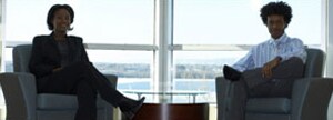 Two people sitting in armchairs