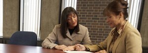 Two businesswomen at conference table