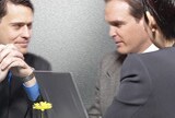 Businessmen looking at laptop
