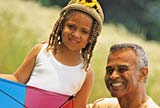 Portrait of a granddaughter and her grandfather having fun in a park
