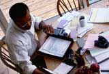 Man reading documents at his home office