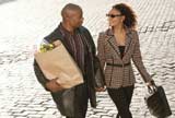 Couple walking home with sacks of groceries