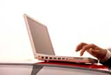 Man's hand typing on laptop