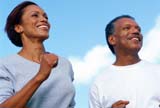 Couple in their 50s jogging in a nice day