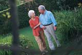 Elderly couple chatting in their backyard