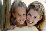Mom and daughter smiling