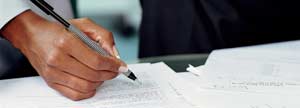 Woman's hand signing a document