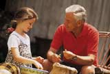 Little girl chatting with her grandfather