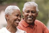 Elderly couple riding a bike