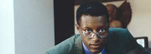 Man with glasses leaning forward