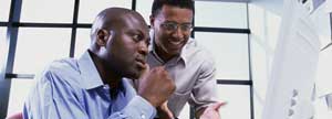 Two men using a computer