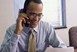 Bussinessman in his desk using his cellphone