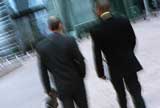 2 businessmen walking on the street