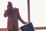 Businessman with briefcase talking on his cellphone
