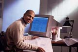 Man at his desk turning his head