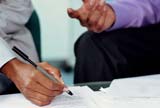 Man's hand signing contract