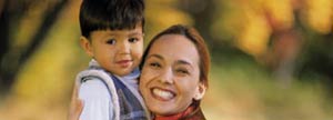 Mother holding her son outdoors