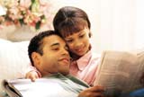 Young couple reading the newspaper