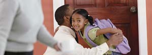Man getting her daughter ready for school