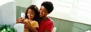 Woman and daughter in front of a computer