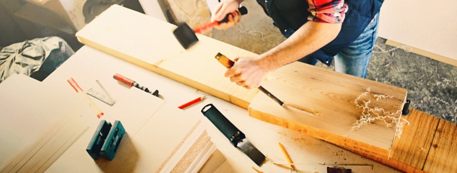 image of a man working with wood and tools
