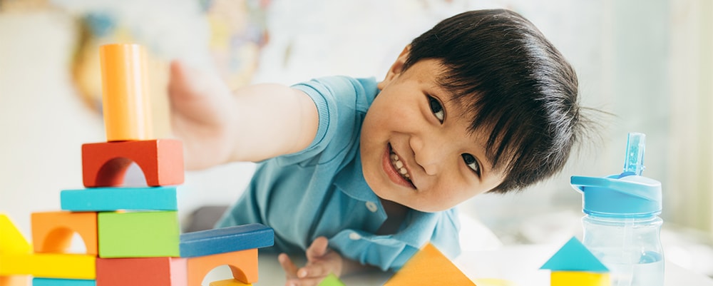 Boy playing with building blocks