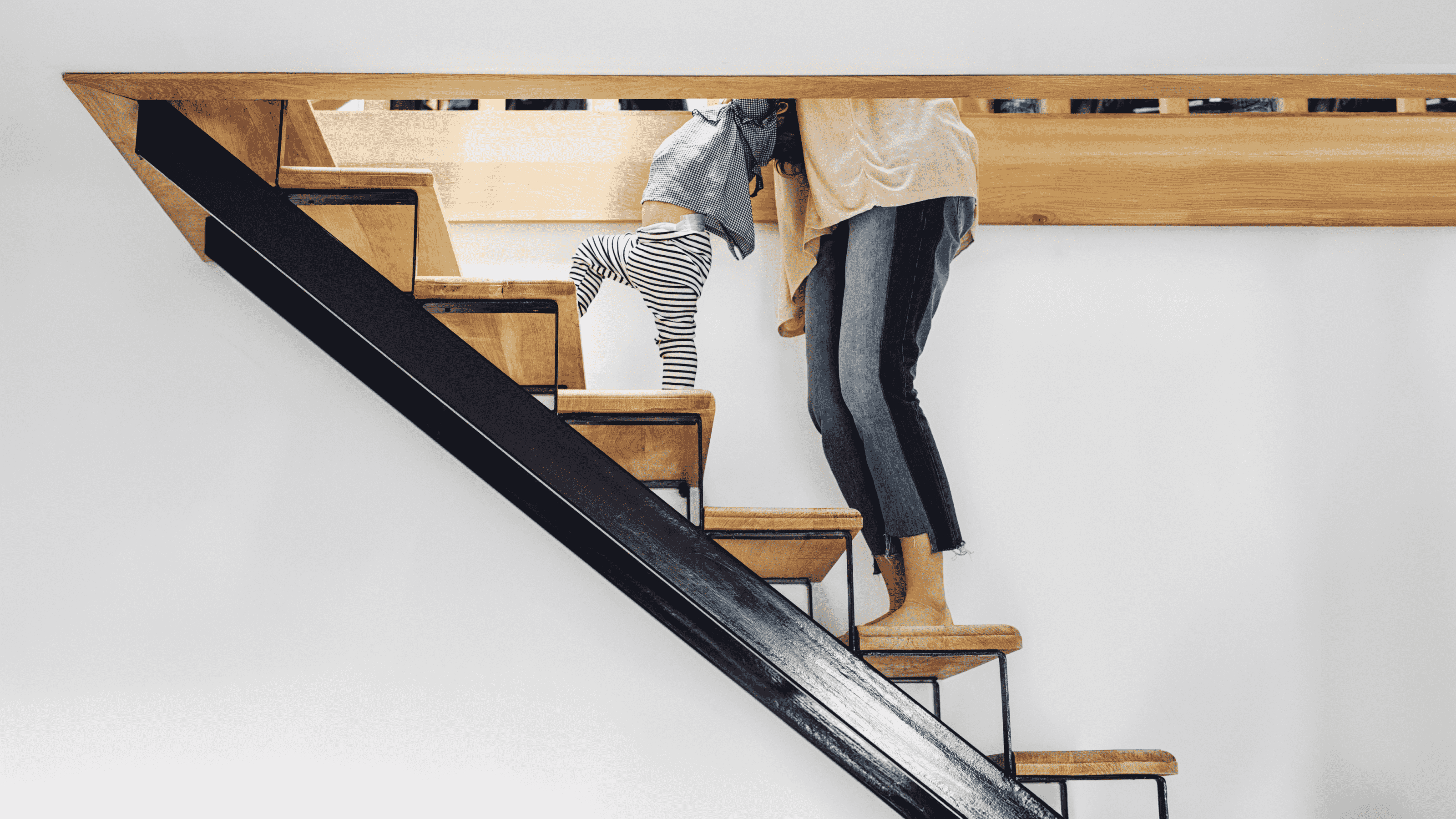 A women and child walking upstairs