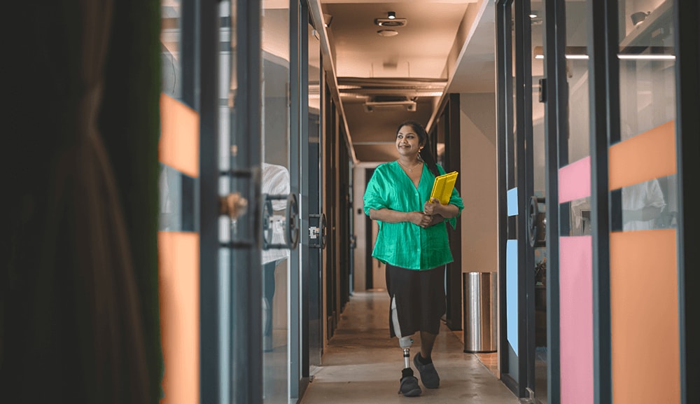 Women walking through hallway holding files.