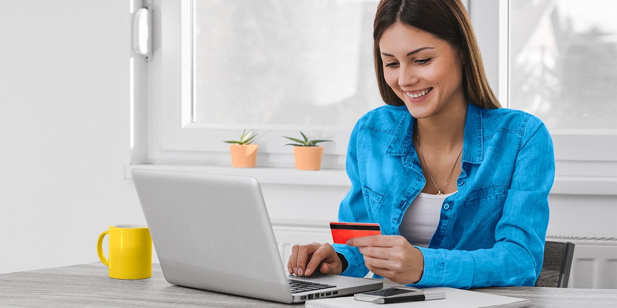 Girl increasing her credit imit on her laptop at home