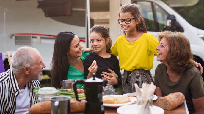 Family sharing a lunch outdoors during spring