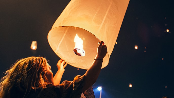 woman holding up a paper lantern