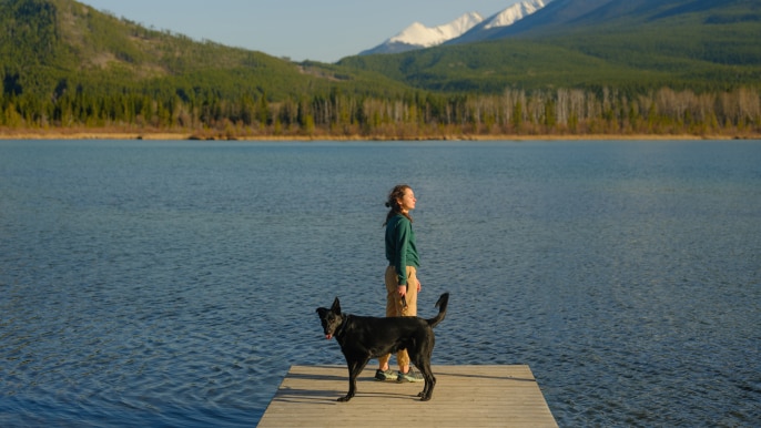 woman and dog on dock