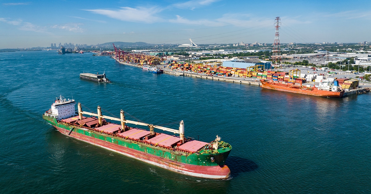 Cargo ship in water near pier