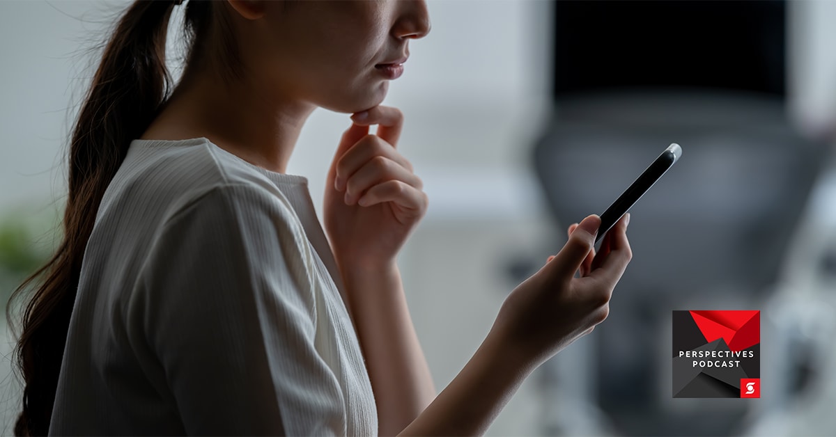Woman holding phone with hand to chin