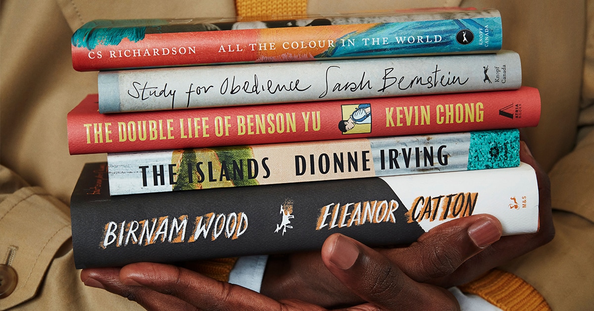 Close-up of hands holding shortlisted books