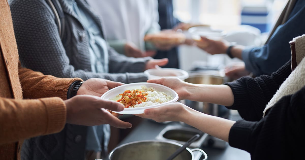 Food being handed to people in line-up