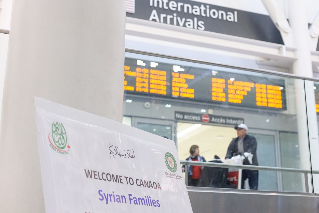 Sign at airport: "Welcome to Canada Syrian Families"