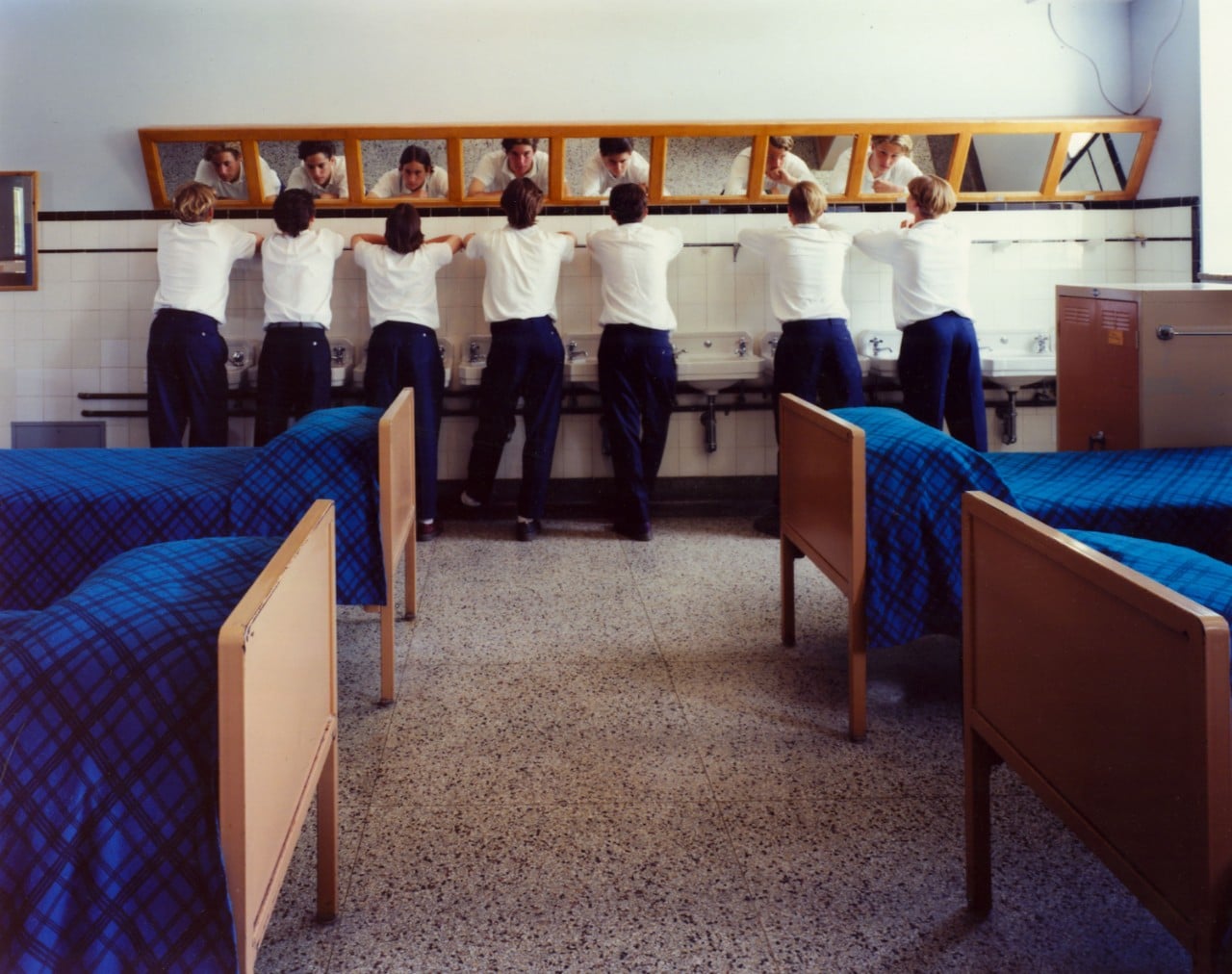 Group of male students at row of sinks