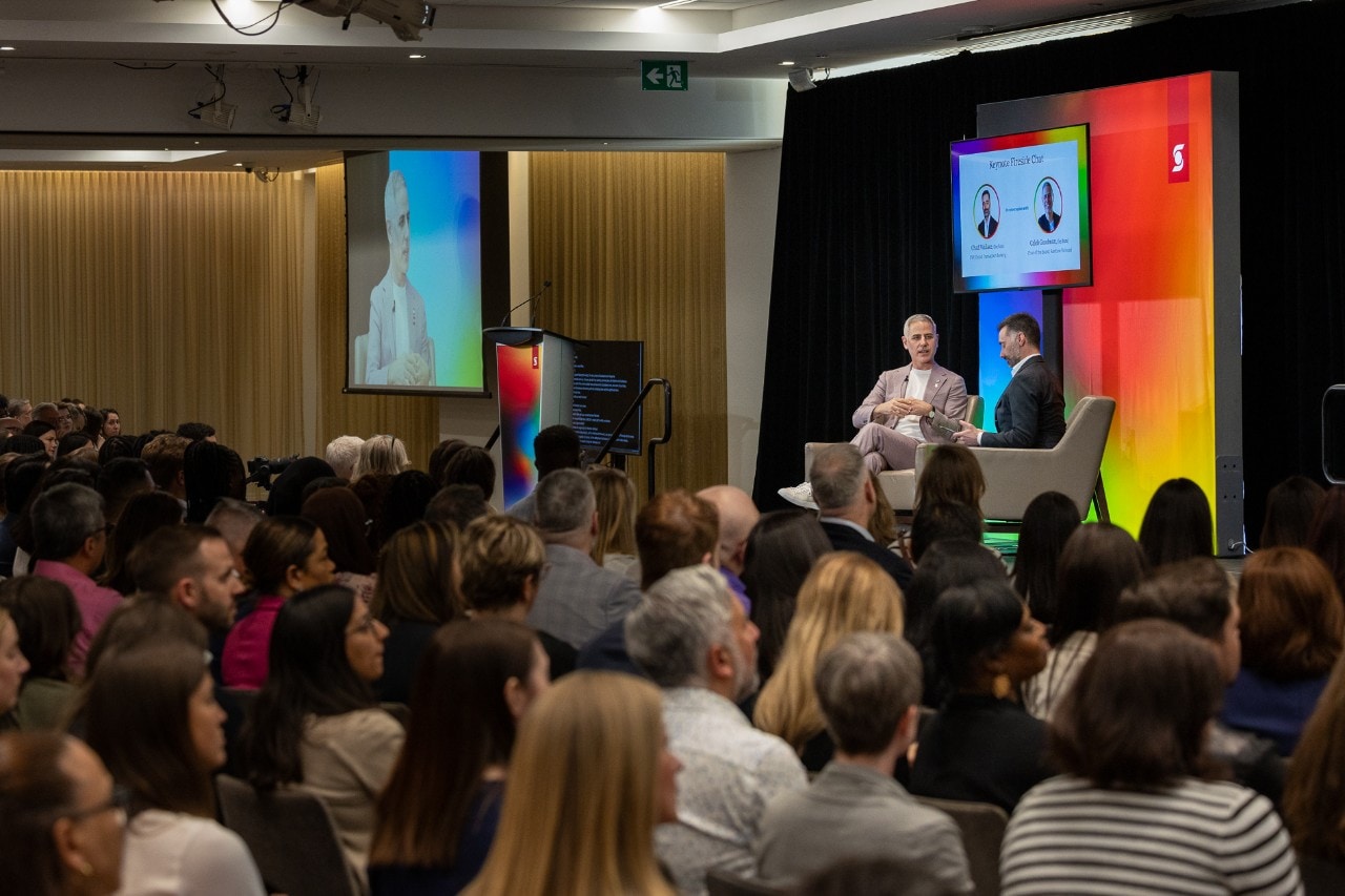 Crowd and Caleb Goodman on stage at Pride event