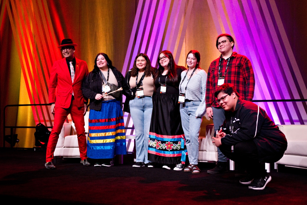 Group on stage posing for group photo