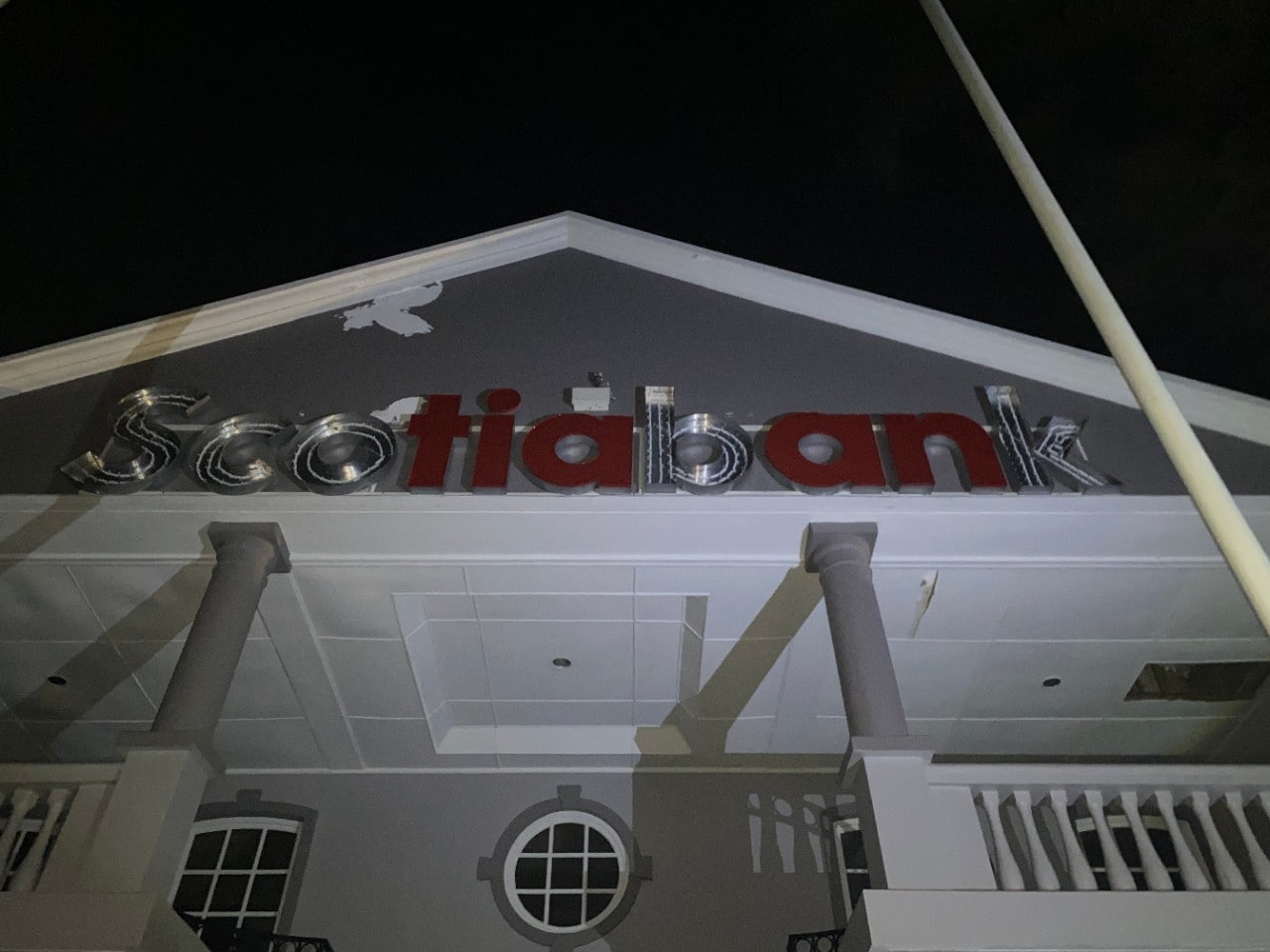 A Scotiabank sign on a branch building with several letters missing
