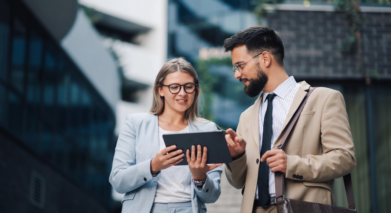 two employees talking while walking outside