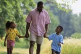 Family holding hands at a park